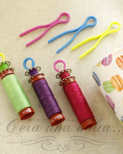 Ganci in plastica portabobine