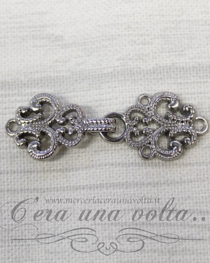 Agganciature con intrecci e intarsi argento
