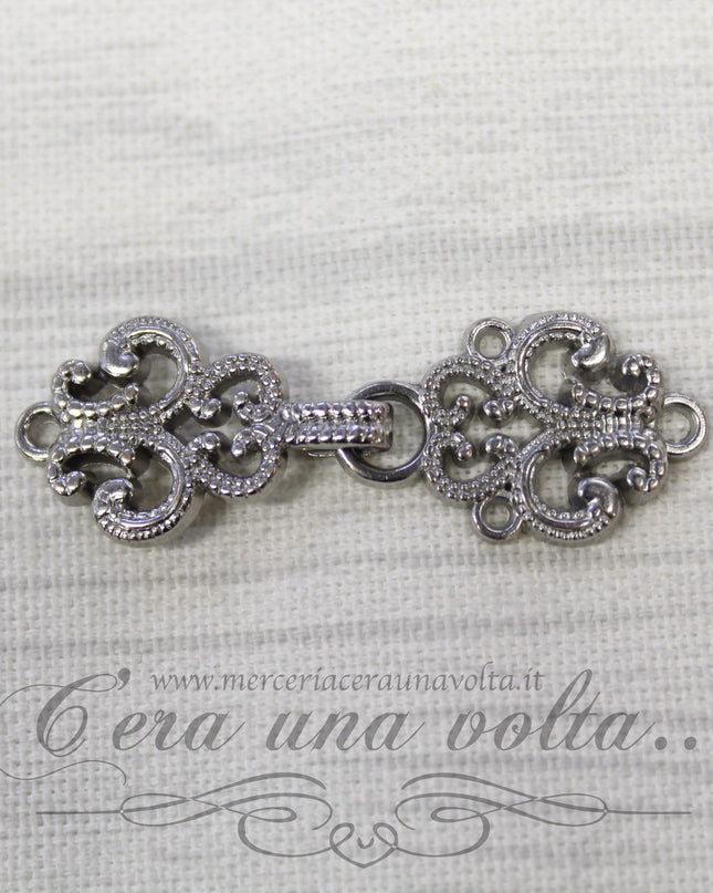 Agganciature con intrecci e intarsi argento
