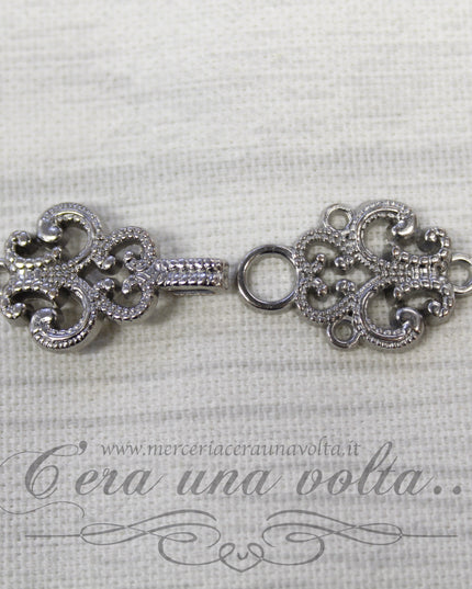 Agganciature con intrecci e intarsi argento