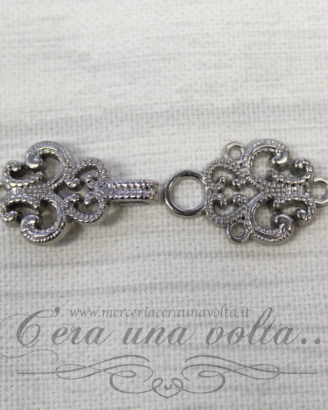 Agganciature con intrecci e intarsi argento