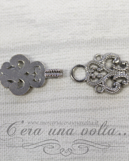 Agganciature con intrecci e intarsi argento